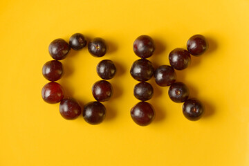 Portrait of OK sign made of grapes