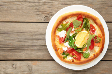 Margherita Italian pizza with cheese and tomato garnished with on grey wooden table with copy space