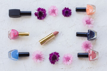 Woman cosmetics with flowers on a white background