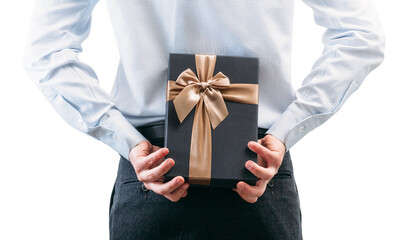 Business man holds a gift behind his back.Guy in a shirt with a tie on a white background. Gift box with a golden ribbon. .