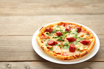 Tasty Italian pizza with sausage on grey wooden table with copy space