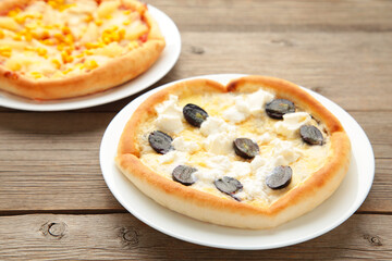 Delicious italian pizzas on grey wooden table