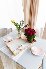 Still life of a plate and flowers on a table