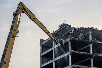Fototapeta na wymiar Building House destruction Demolition site Excavator with hydraulic crusher machine ruin house