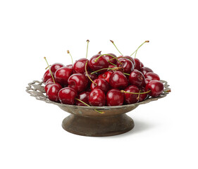 round red ripe sweet cherries in a copper bowl isolated on a white background