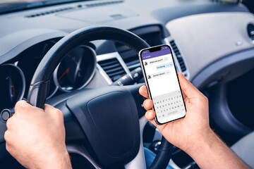 A man driving a car with  phone