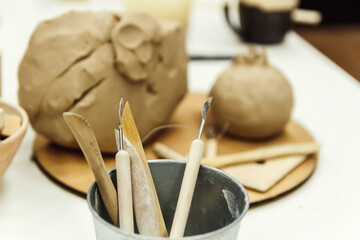 Sculpting tools set and clay on  table.