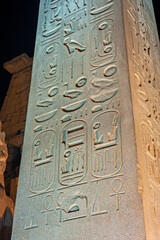 Hieroglyphic carvings on obelisk at Luxor Temple during night