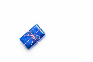 Blue gift box with red ribbons isolated on white background