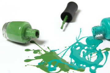 Fototapeta premium Blue and Green Spilled Nail Polish on White Background