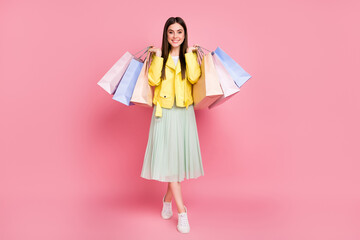 Full length body size view of her she nice-looking attractive pretty fashionable cheerful cheery girl carrying new things goods isolated on bright vivid shine vibrant yellow color background