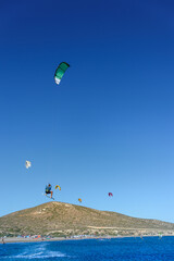 Fototapeta na wymiar Kitesurfer in big jump in air on Prasonisi beach (Rhodes, Greece)