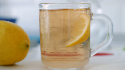 Fresh Sweet and Hot Cup with Tea and a Slice of Lemon at Breakfast Time in the Morning
