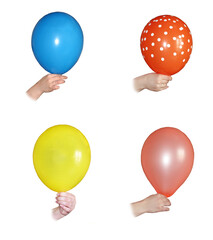 The hand holds an inflatable ball. Isolate on white background. Balls are red, pink, blue and yellow.