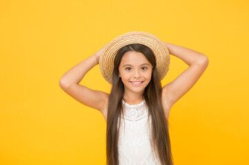 Splash of summer. happy childhood. joyful summer holiday and vacation. kid seasonal fashion. carefree beauty on yellow background. smiling kid in straw hat. little child ready for beach activity
