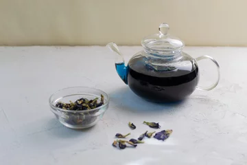 Foto op Aluminium Blue Thai Anchan tea in a glass teapot. Amazing indigo color. Copy space. © Inna
