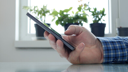 Elderly Person Isolated in Quarantine at Home Texting Using Cellphone Technology, Social Distancing Lifestyle in Coronavirus Pandemic