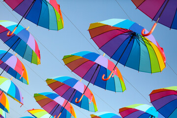 Umbrellas in the color of the rainbow against the  sky.