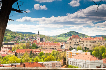 Fototapeta na wymiar State castle of Cesky Krumlov a the towns red roofs from above
