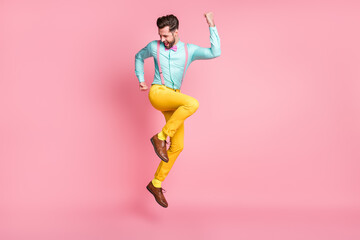 Fototapeta na wymiar Full length body size view of his he nice well-dressed attractive classy cheerful cheery glad brunet guy gentleman jumping rejoicing having fun isolated over pink pastel color background