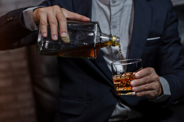 Closeup businessmen holding a glass of whiskey