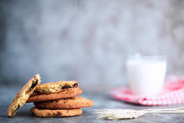 Stacked home made cookie view with a glass of milk and wheat spike studio shot