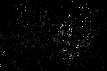 Splashes and drops of water are on a black background.
