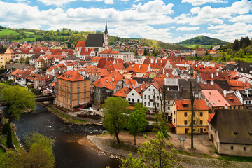 Fototapeta na wymiar Cesky Krumlov with Vltava river seen from above with red roofs and St. Vitus church on a beautiful day