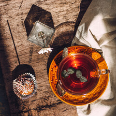  Hot tea with mint and cake. Square format photo