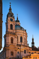 Fototapeta premium Illuminated St. Nicholas church in Lesser town of Prague during twilight