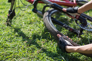 Bicycle tires leak, Cyclists checking bicycle wheels, Close-up.