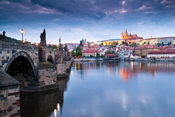 Side view of Charles bridge and illuminated Prague castle just after sunset