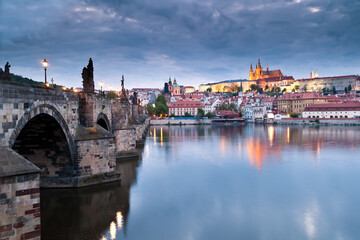 Side view of Charles bridge and illuminated Prague castle just after sunset