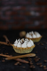 Cappuccino tart with cinnamon sticks and coffee beans on rustic wooden table