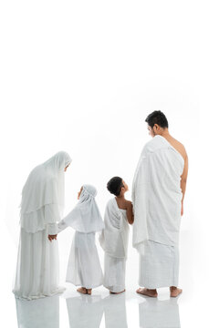 asian muslim family hajj shot from behind with copyspace