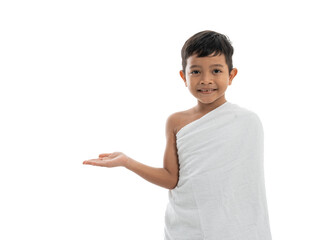 asian boy with ihram presenting copyspace. hajj and umrah kid concept