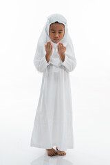 Muslim kid praying and wearing ihram isolated over white