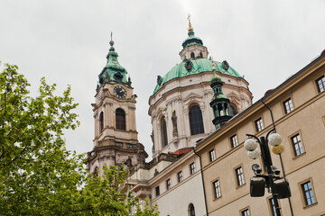 Fototapeta na wymiar Framed view of St. Nicholas church from Malostranske square