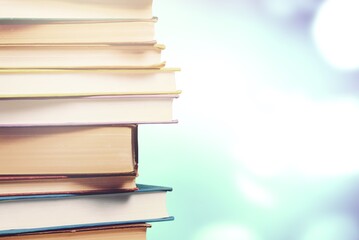Stack of colorful books on blurred background