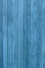 Fototapeta premium Blue wooden background, old age effect. Old boards painted light blue, close-up. Vertical image.