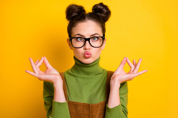 Portrait of childish crazy girl inflate cheeks make om sign meditate asana charka exercise wear...