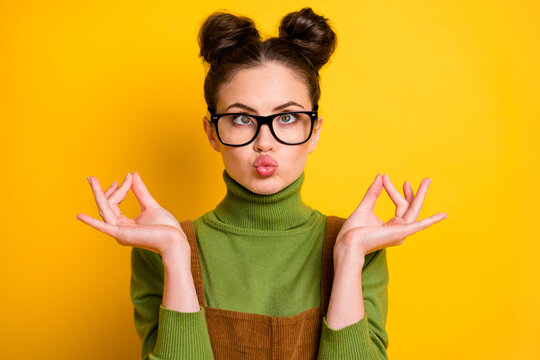 Portrait of childish crazy girl inflate cheeks make om sign meditate asana charka exercise wear green pullover isolated over bright shine color background