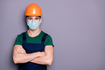 Close-up portrait of his he attractive healthy guy workman wearing safety gauze protective mask glasses mers cov infection influenza prevention folded arms copy space isolated grey color background
