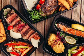 flat lay of food in plastic dish on wooden table