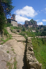 Stone stairs leading up against the blue sky and unusual mountains in Girona, Spain