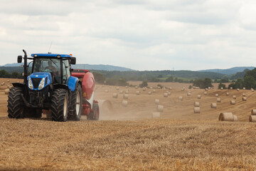 traktor making hay bales in a field - hay bale making machine © zera ruzgar