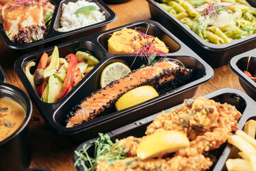 group of food in plastic dish on table. take away food