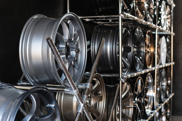 wall of alloy wheels in the store. Auto repair shop background. Auto Wheel Service.
