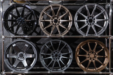 wall of alloy wheels in the store. Auto repair shop background. Auto Wheel Service.