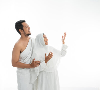 muslim couple presenting copyspace. umrah asian man and woman